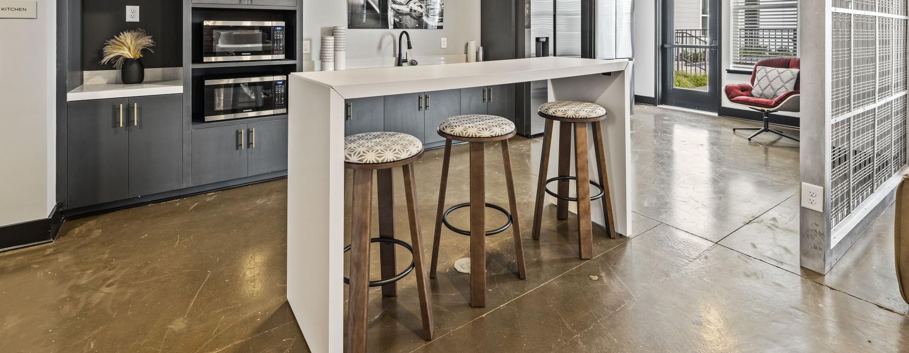a kitchen with stools and a table