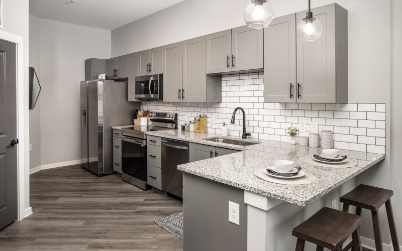a kitchen with gray cabinets