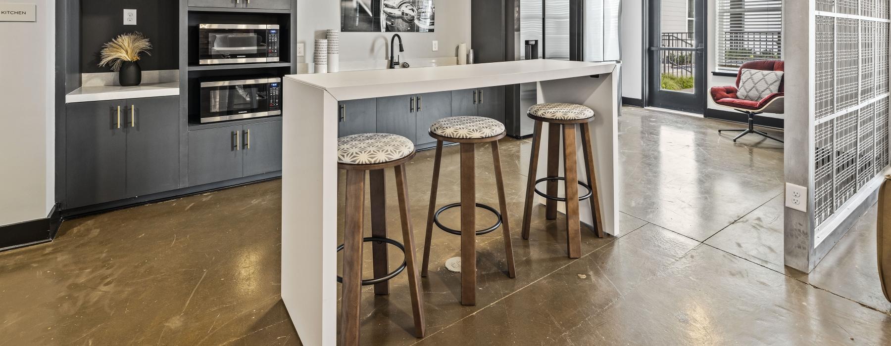 a kitchen with stools and a table