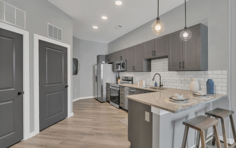 a kitchen with gray cabinets