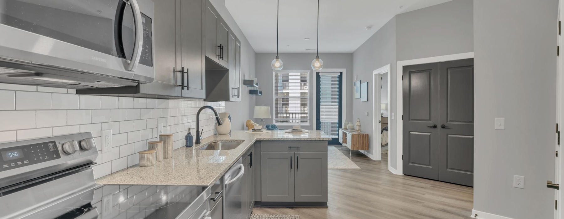 a kitchen with gray cabinets